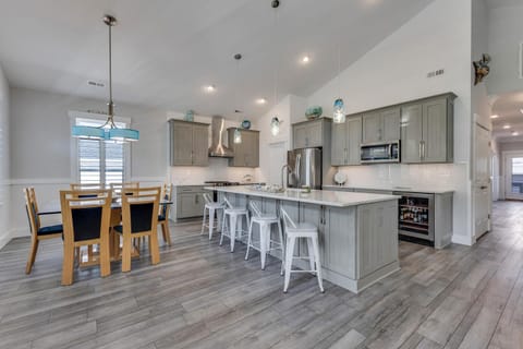 Cook together in your spacious gourmet kitchen featuring modern appliances, a large island for gathering, and open dining space perfect for memorable meals.