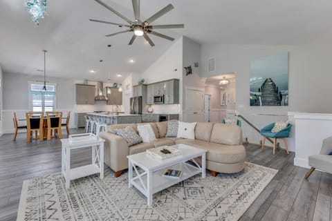 Unwind in your open-concept living space with soaring ceilings, stylish furnishings, and a fully equipped kitchen perfect for creating memorable meals.