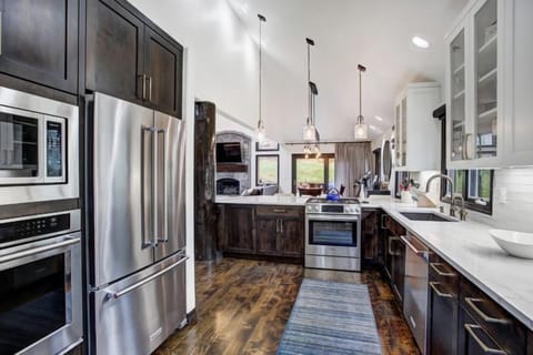 The stylish kitchen features modern appliances and a spacious layout, perfect for family gatherings after a day on the slopes.