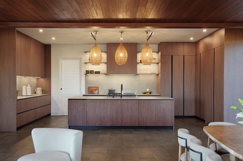 Chef’s kitchen with large island, pendant lighting, and high-end appliances.