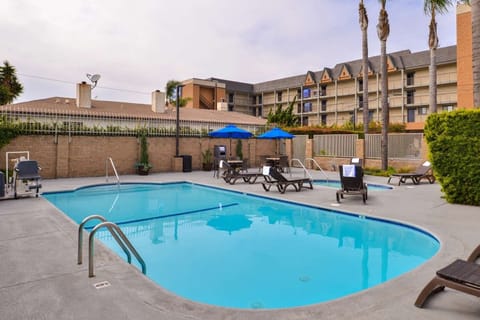 Dive into a sparkling pool oasis with sunny loungers.