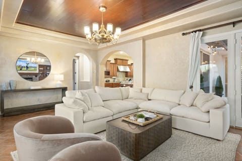 Elegant living room w/ plush seating, warm lighting & refined details for relaxed gatherings