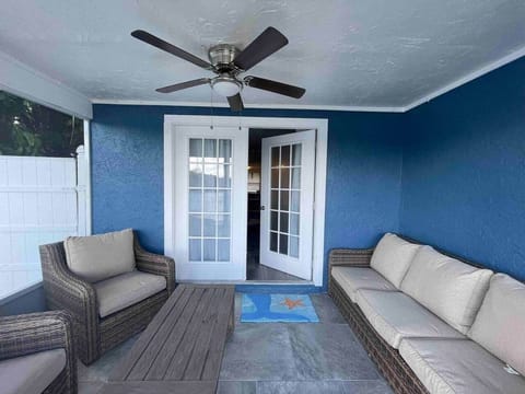 Screened, covered patio and outdoor living space overlooking the serene lake