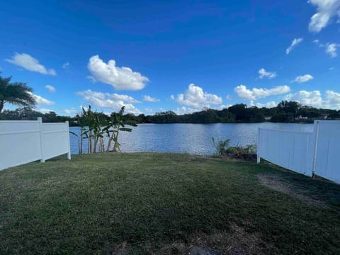Peaceful lake view with privacy fencing on both sides for a quiet secluded stay.