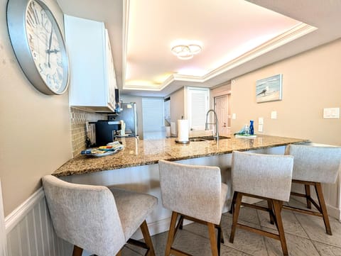 Bright, open kitchen with cozy breakfast bar seating