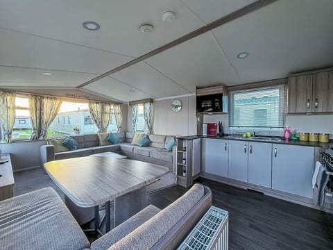 Bright and airy living area with panoramic windows and cozy seating