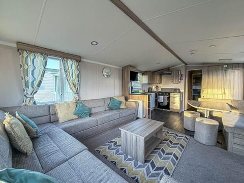 Cozy living room with plush seating and modern kitchen amenities