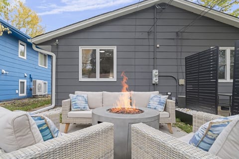 Outdoor Patio | Cozy Wicker Seating with Fire Pit and Tropical Accent Pillows