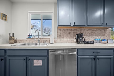 A tidy counter with a coffee drip and natural window light for easy morning coffee.