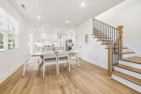 This space features plush seating, a large Smart TV, dining table for 6, and a large kitchen island with bar seating.