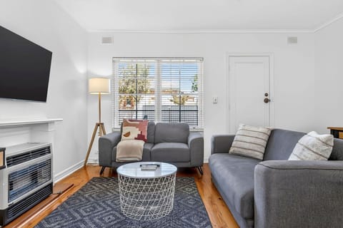 Light-filled living area with comfy seating, perfect for putting your feet up after a day out.