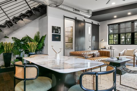 Chic industrial dining vibes with designer furniture, lush greenery, and bold architectural details.