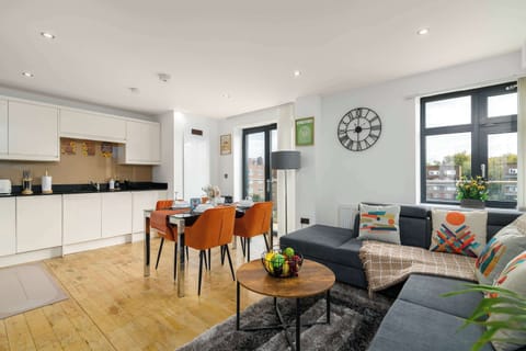 Bright open-plan living, dining and kitchen area, seamlessly flowing onto the private balcony—perfect for relaxing, dining and enjoying the indoor-outdoor space