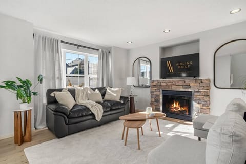 Main floor living room with a gas-lit fireplace, 50` Smart TV, and luxurious seating options to kick back on after a day of adventures.