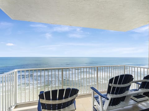 Oceanfront balcony with panoramic sea views and cozy seating