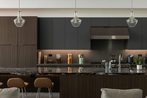 A closer look at the gourmet kitchen, highlighting the gas range, custom cabinetry, and premium stone countertops.