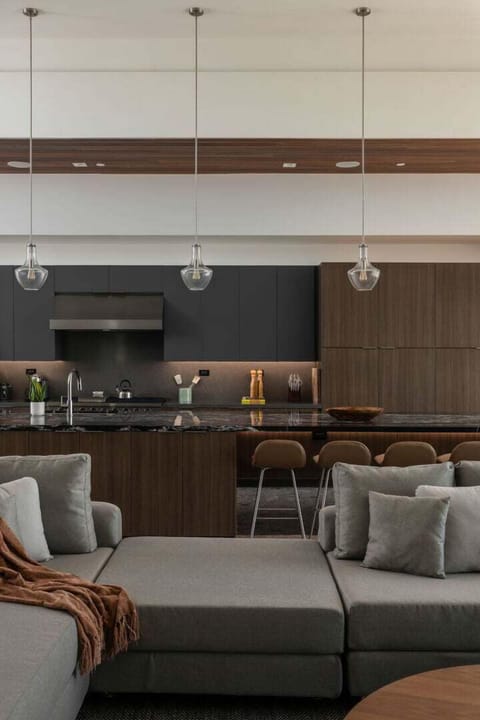 A close-up view of the custom kitchen cabinetry and the large island bar with seating, perfect for a casual meal or happy hour.