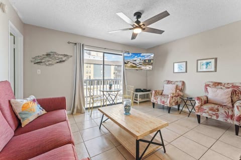 Coastal living room has a sliding door with a view of the beach access and the gulf!