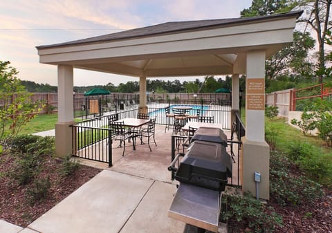 Gather for relaxed cookouts under the shaded pavilion by the pool.