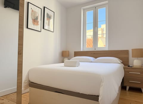 Bedroom 1 with double bed, fresh linens, and bedside lighting