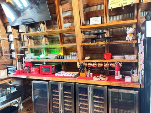 Dishes , sink , coffee pot , toaster ,pizza oven