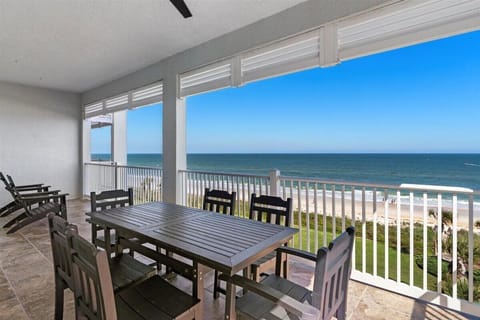 Spacious balcony with outdoor dining and stunning panoramic ocean views.
