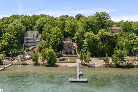 OVERVIEW:   Aerial shot of the incredible home and it's gorgeous private beach, lakefront, and dock!