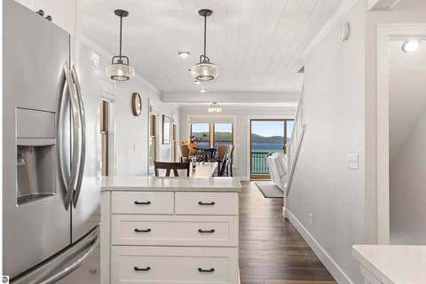 KITCHEN (MAIN FLOOR): The home has a beautiful modern kitchen with all appliances (including a dishwasher) and a good supply of cooking and dining utensils