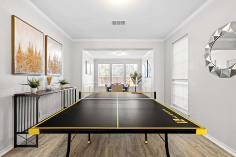 Spacious game room featuring a ping pong table, perfect for family fun and entertainment. A great space to relax and enjoy quality time indoors during your mid-term stay near Fort Worth and DFW Airport.