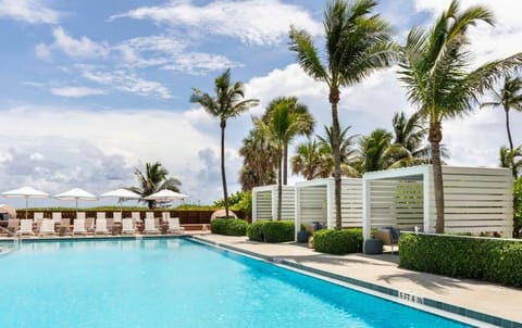 Unwind poolside under swaying palms and private cabanas.