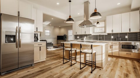 Gourmet kitchen opens to the living and dining areas for easy conversation.