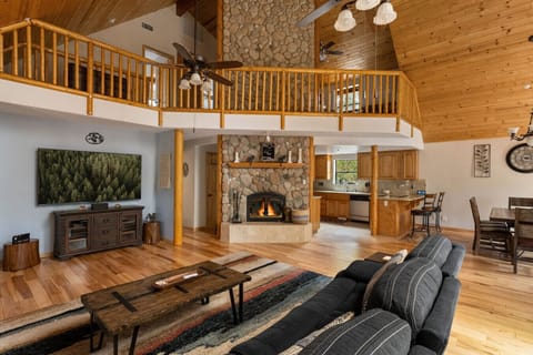 Cozy living space with a stone fireplace and smart TV.