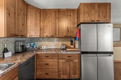 Modern design with sleek appliances and rich wood accents for a familair feel.