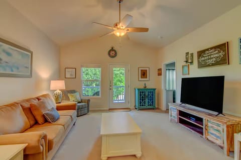 Relaxing living room with TV and balcony access