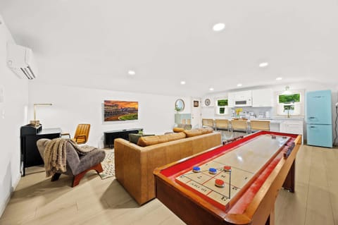 Living Room: Relax and unwind in this spacious open-concept living area, perfect for games and gathering.