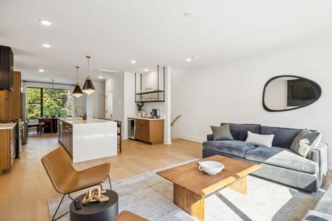 Living Room: Where modern design meets cozy comfort — unwind with friends and family in this elegant, sun-filled living room.