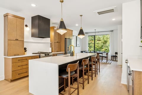 Kitchen: Sleek lines, warm tones, and high-end touches — the perfect kitchen for cooking, entertaining, and enjoying life together.