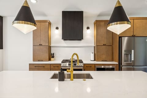 Kitchen: Sleek lines, warm tones, and high-end touches — the perfect kitchen for cooking, entertaining, and enjoying life together.