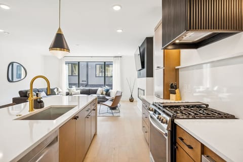 Kitchen: Sleek lines, warm tones, and high-end touches — the perfect kitchen for cooking, entertaining, and enjoying life together.