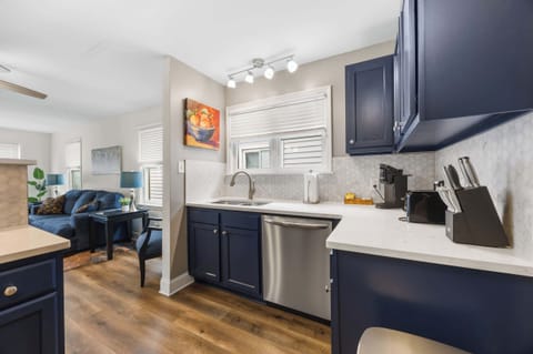 Kitchen: Cook and Connect – Enjoy this inviting kitchen with bold blue cabinetry, sleek finishes, and cozy seating that makes mealtime a delight.