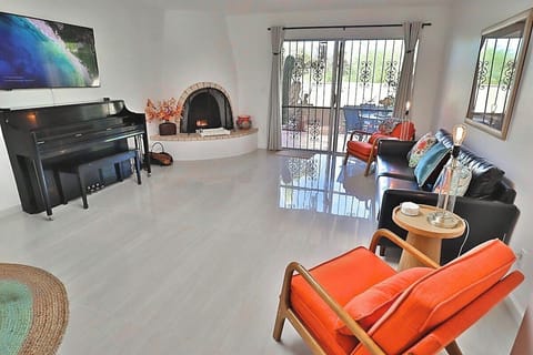 Living space with decorative fireplace and piano