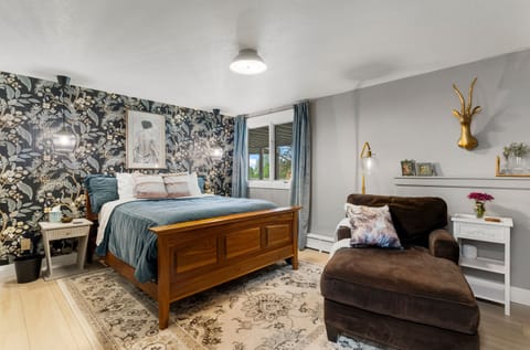 Bedroom 1, queen size bed, sitting area, and fireplace. 