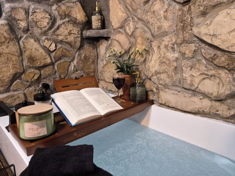 52 in soaking tub.   The stones in the surround are from the property.  