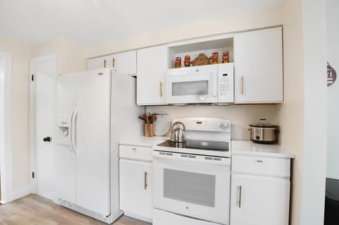 Kitchen includes crock pot, blender, mixer, and cookware. 