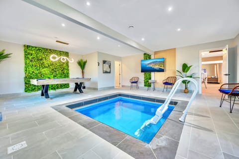 Indoor heated plunge pool with billiards table and 65" smart tv
