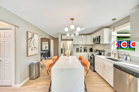 Large open kitchen with waterfall island and all cooking utensils needed to cook