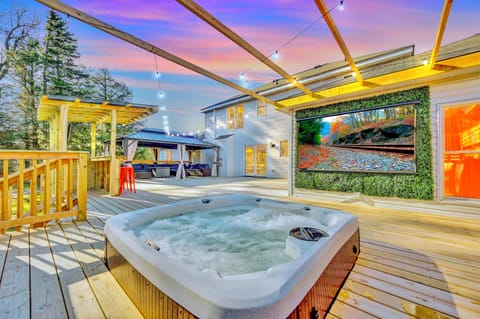 Outdoor hot tub with movie theater on massive deck, loaded with fun