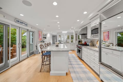 Fully equipped kitchen with modern appliances, dining area & seating for 8