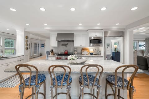 Fully equipped kitchen with modern appliances, dining area & seating for 8