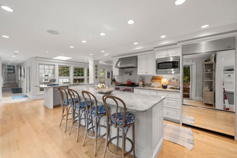 Fully equipped kitchen with modern appliances, dining area & seating for 8